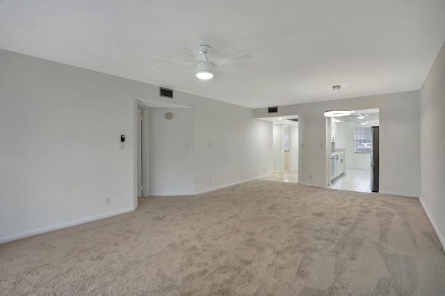 spare room featuring ceiling fan and light colored carpet