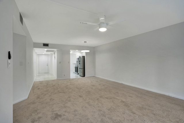 carpeted spare room with ceiling fan