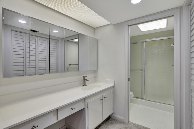 bathroom featuring toilet and vanity