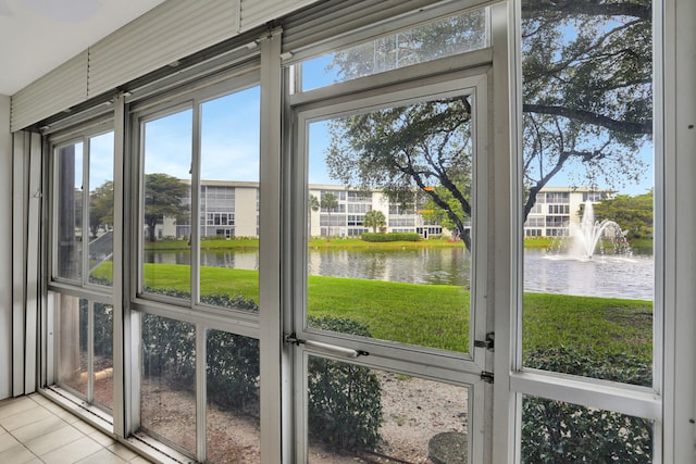 unfurnished sunroom with a water view