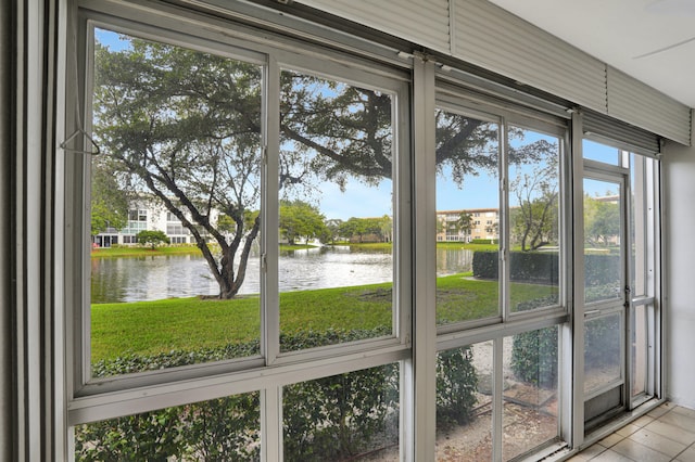 unfurnished sunroom featuring a water view and a wealth of natural light