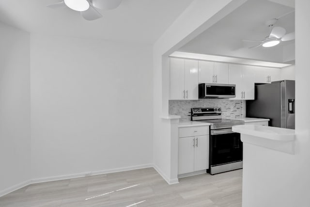 kitchen featuring ceiling fan, stainless steel appliances, white cabinets, and tasteful backsplash