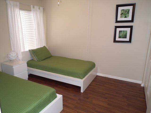 bedroom with dark hardwood / wood-style floors