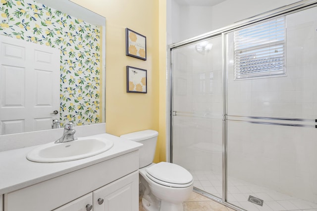 bathroom with toilet, walk in shower, vanity, and tile patterned floors