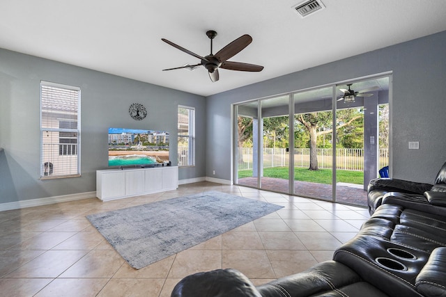 living room featuring ceiling fan and light tile patterned flooring