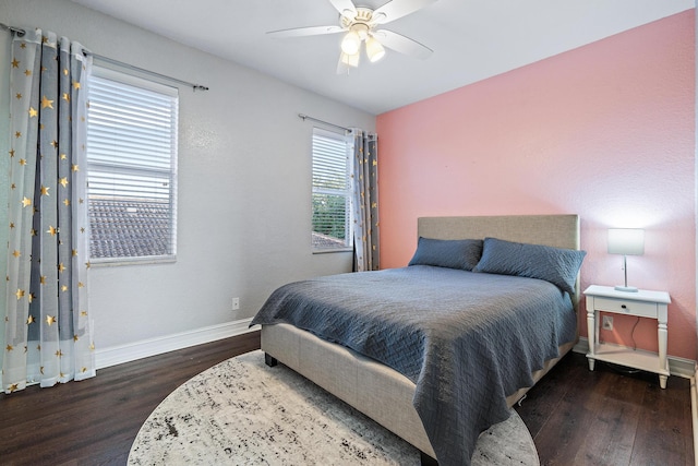 bedroom with dark hardwood / wood-style floors and ceiling fan