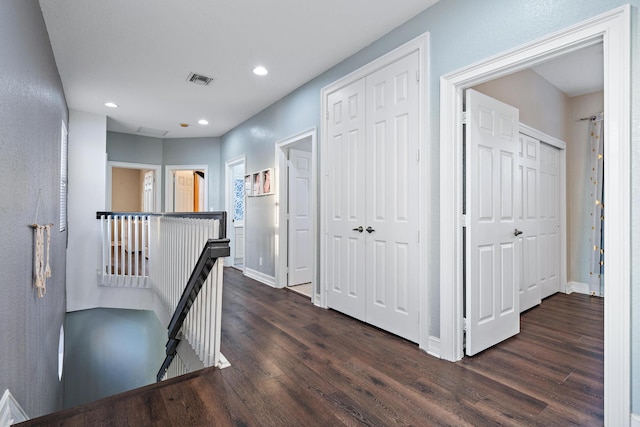 corridor with dark hardwood / wood-style flooring