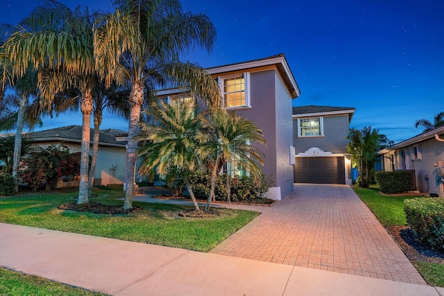 view of front of house with a front lawn and a garage