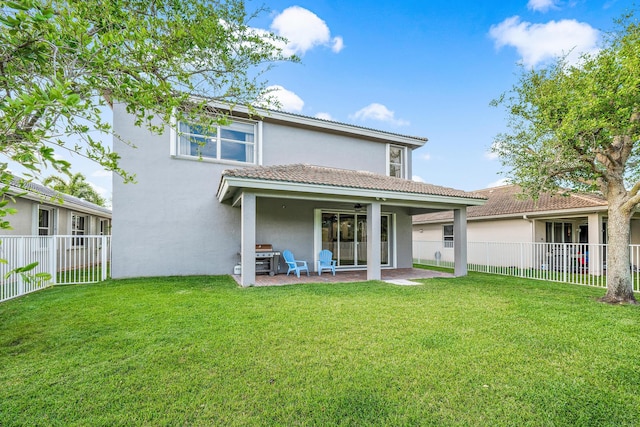 rear view of property with a patio and a lawn