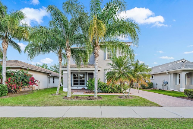 mediterranean / spanish home with a front yard