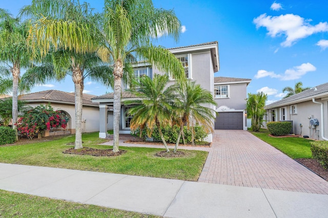 view of front of house featuring a front yard and a garage