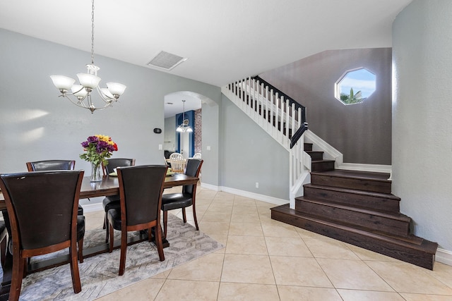 dining space featuring an inviting chandelier and light tile patterned floors