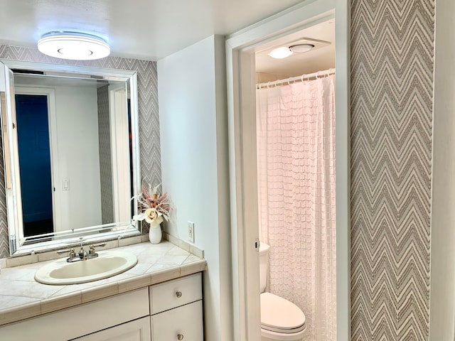 bathroom featuring toilet and vanity