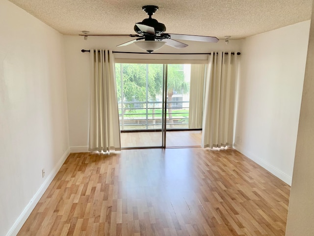 unfurnished room featuring ceiling fan, a textured ceiling, and light hardwood / wood-style flooring