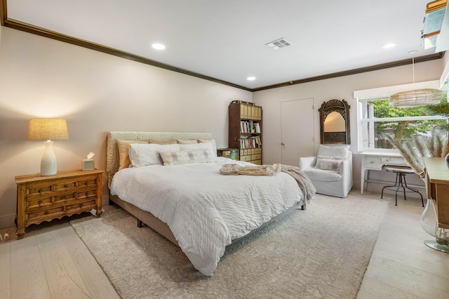 bedroom with light hardwood / wood-style flooring and crown molding