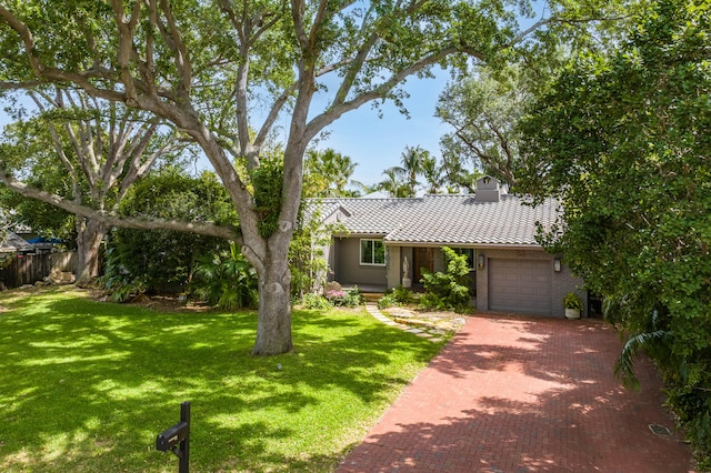 view of front facade with a garage and a front yard