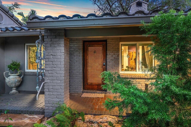 view of exterior entry at dusk