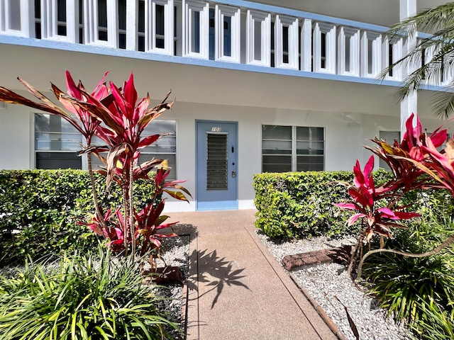 view of exterior entry featuring a balcony