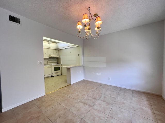 interior space with ceiling fan with notable chandelier, a textured ceiling, light tile patterned floors, white range with electric cooktop, and hanging light fixtures