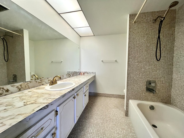 full bathroom featuring tile patterned flooring, vanity, toilet, and tiled shower / bath