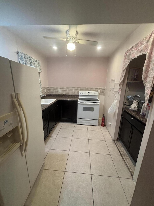 kitchen featuring ceiling fan, sink, light tile patterned floors, and white appliances