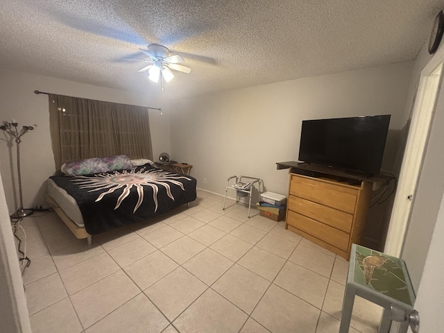 tiled bedroom with a textured ceiling and ceiling fan