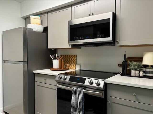 kitchen featuring gray cabinets and stainless steel appliances