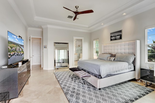 bedroom featuring ensuite bathroom, crown molding, ceiling fan, and a tray ceiling