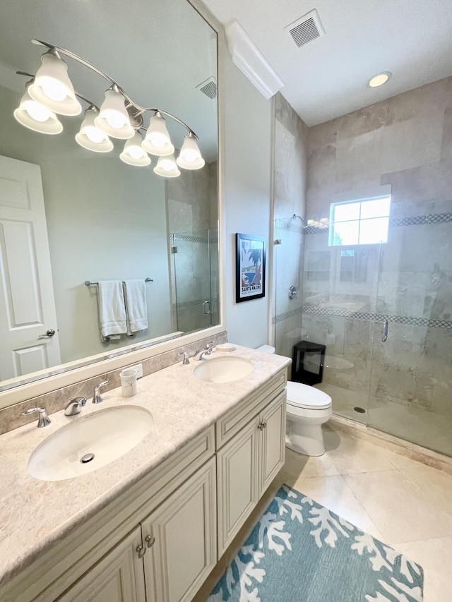 bathroom featuring tile patterned floors, a shower with door, vanity, and toilet