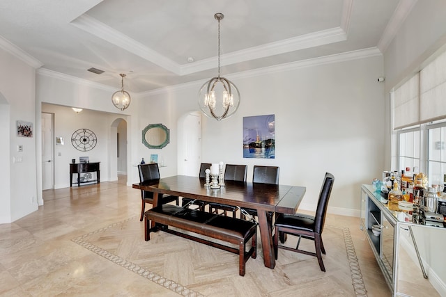 dining room featuring a chandelier, crown molding, and a tray ceiling