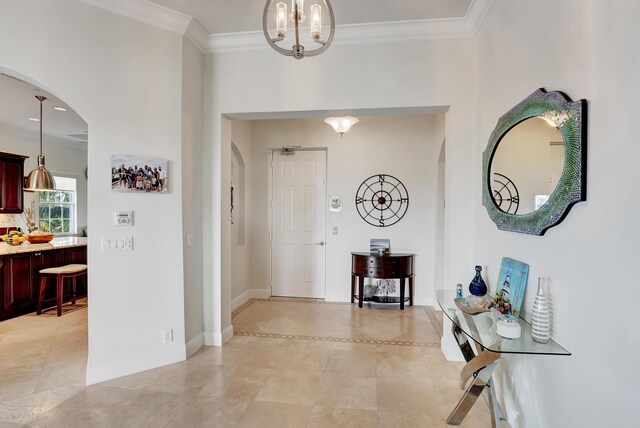 dining room with light parquet floors, a raised ceiling, crown molding, and a chandelier