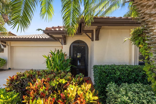 view of exterior entry featuring a garage