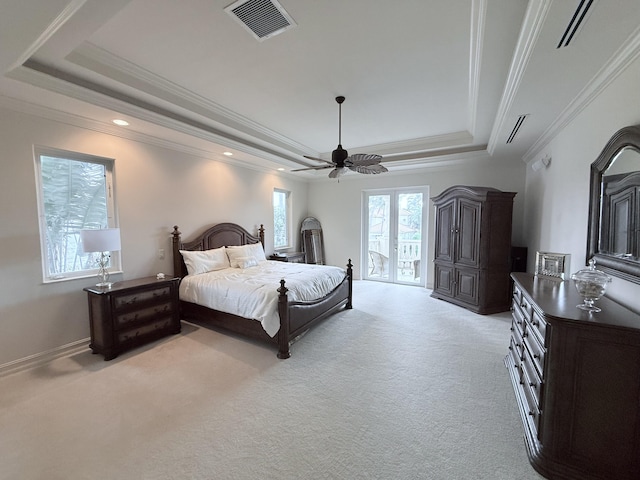 bedroom with a tray ceiling, ceiling fan, crown molding, light carpet, and access to outside