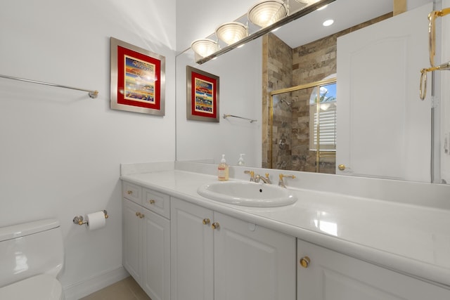 bathroom featuring toilet, vanity, and walk in shower