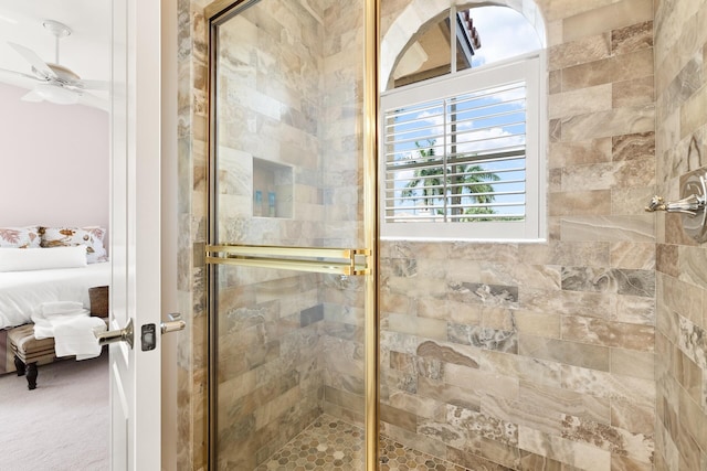 bathroom featuring ceiling fan and an enclosed shower