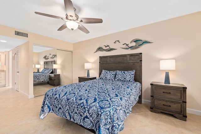 tiled bedroom featuring ceiling fan and a closet