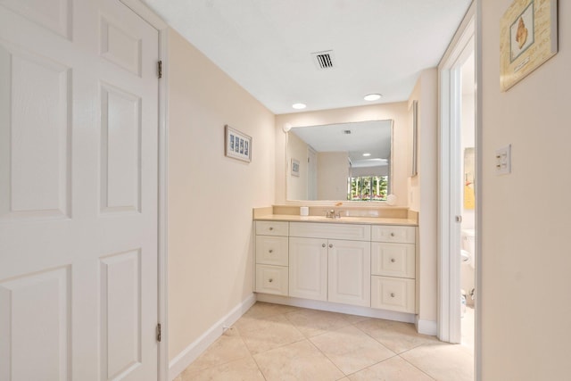 bathroom featuring tile floors and vanity