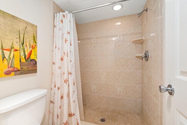 bathroom with curtained shower and toilet