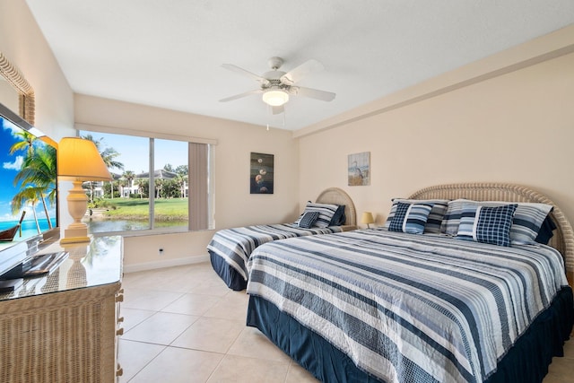 tiled bedroom featuring ceiling fan