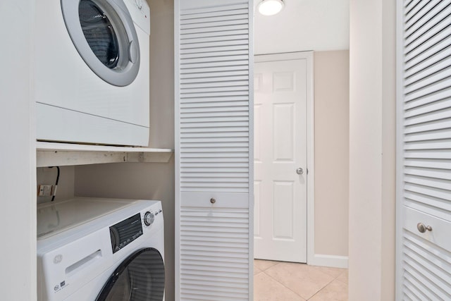 laundry area with light tile floors and stacked washer and clothes dryer