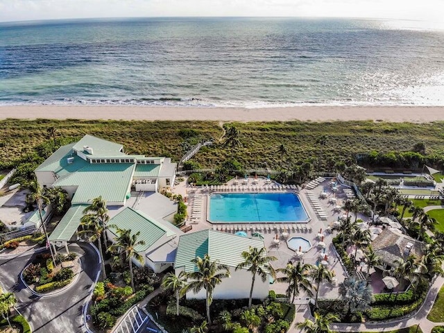 birds eye view of property with a water view and a view of the beach