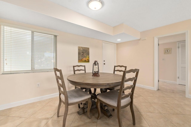 dining space with light tile floors