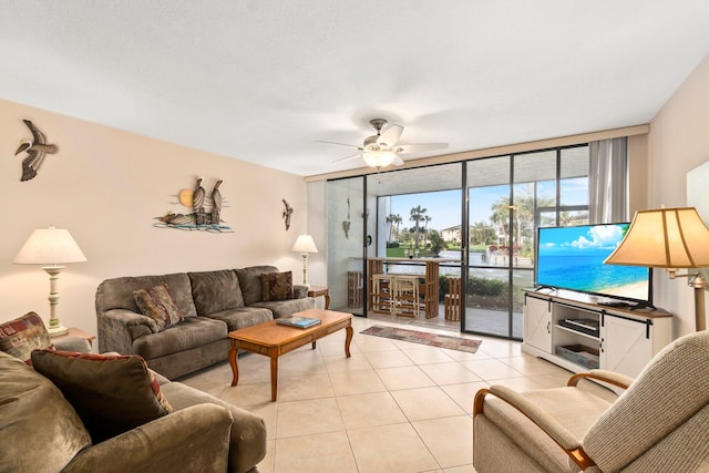 tiled living room with a wall of windows and ceiling fan