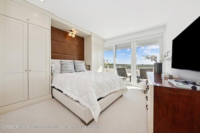 carpeted bedroom featuring access to exterior