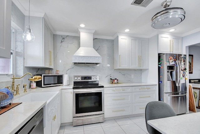 kitchen featuring white cabinets, custom range hood, stainless steel appliances, and ornamental molding