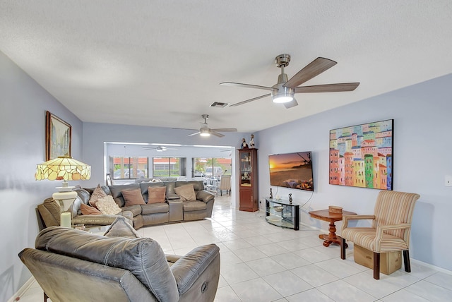 living room with a textured ceiling and light tile patterned flooring