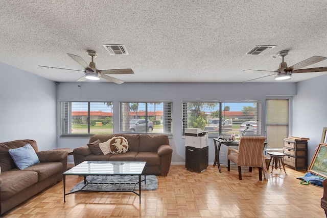 living room with light parquet floors and a textured ceiling