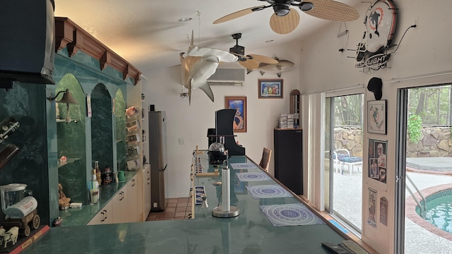 interior space with a textured ceiling, vaulted ceiling, a wall mounted AC, ceiling fan, and tile patterned flooring