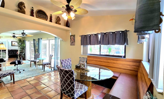 dining area featuring ceiling fan, light tile patterned floors, and a healthy amount of sunlight