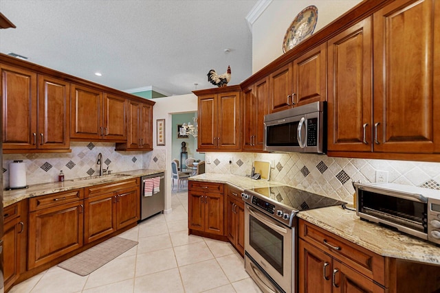 kitchen featuring decorative backsplash, a sink, and stainless steel appliances